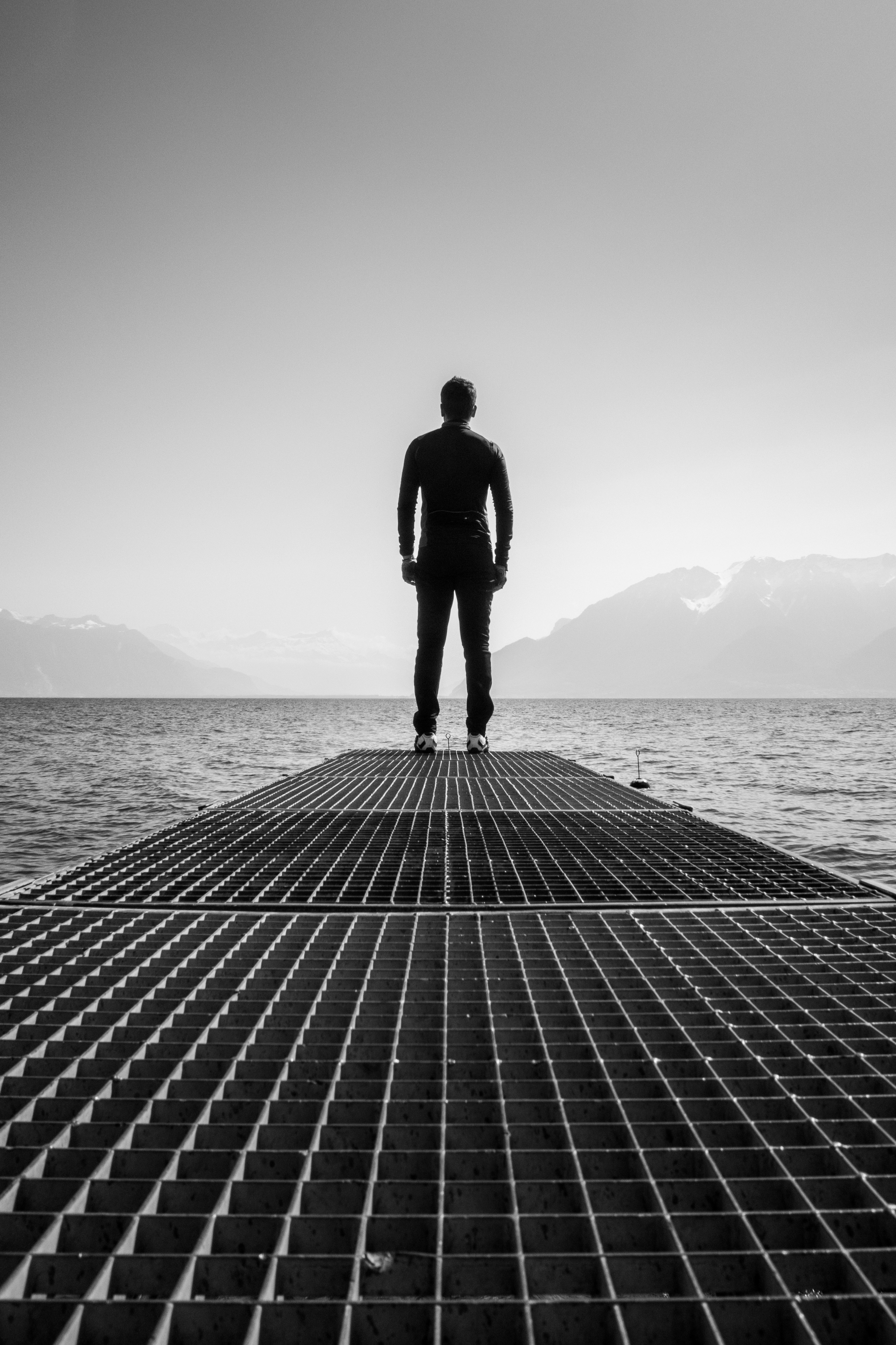 man in black long sleeve shirt standing on dock